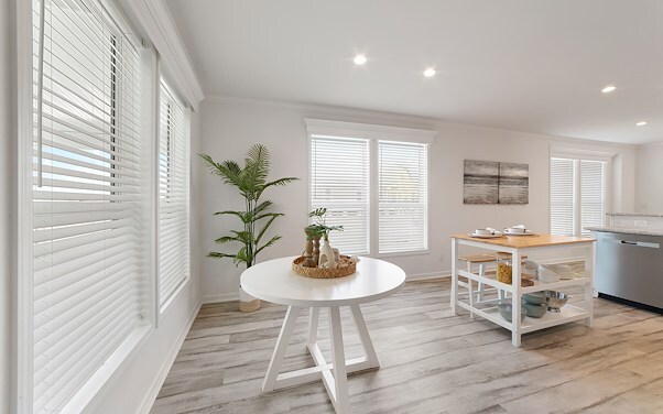 Large area with nice floors, bright lights, and a small white table