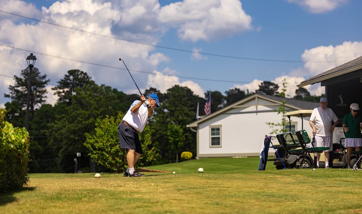Person swinging golf club