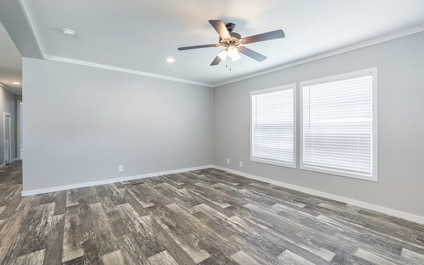 Empty living room with wood flooring and a ceiling fan