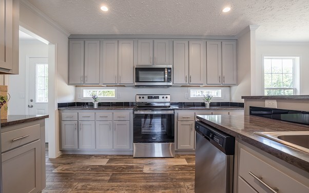 Clean, modern kitchen with gray cabinets and stainless steel appliances