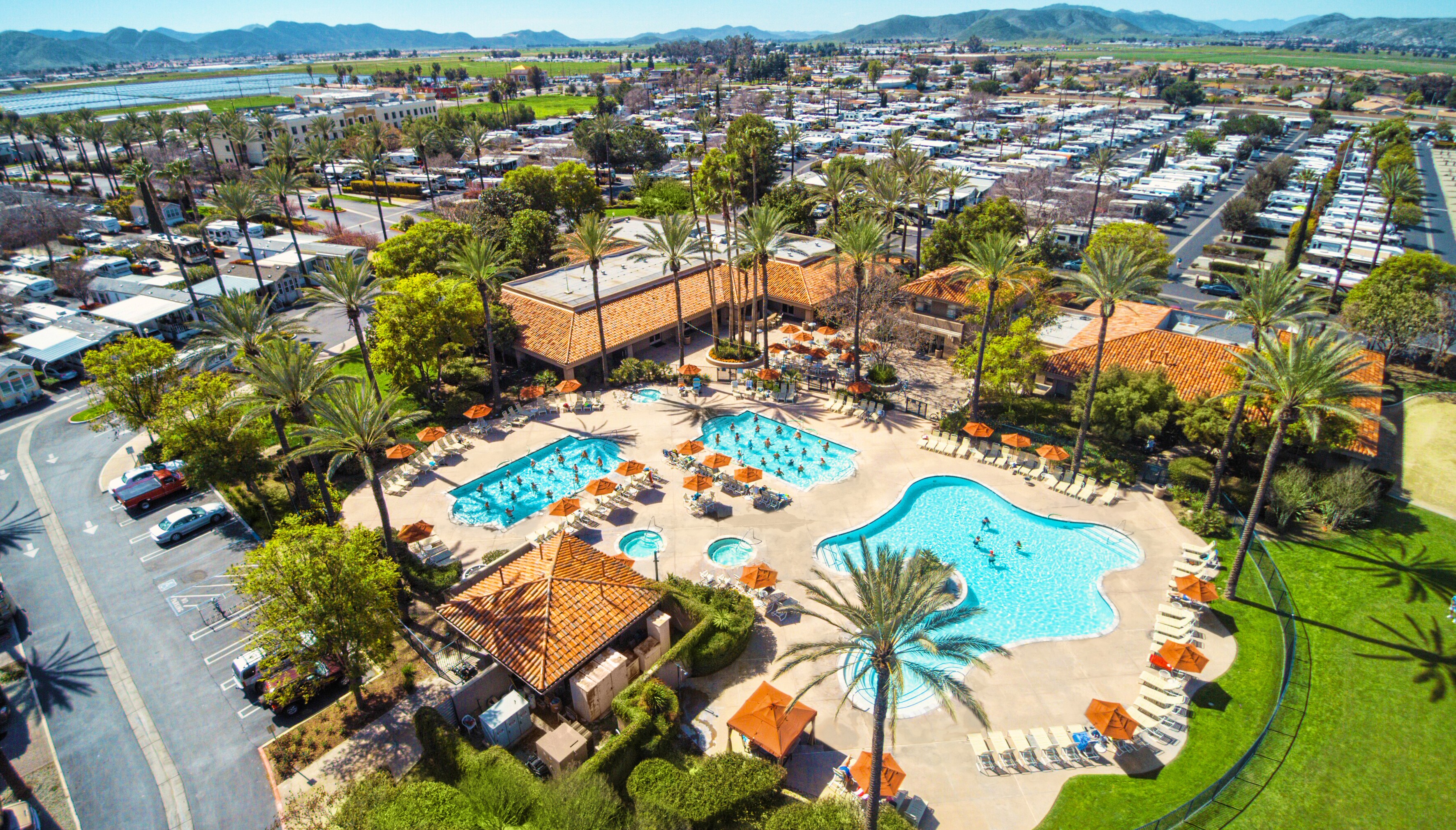 Roll into Resort-Style Living and Pool view of the Palm Springs at Golden Village Palms RV Resort - Hemet California