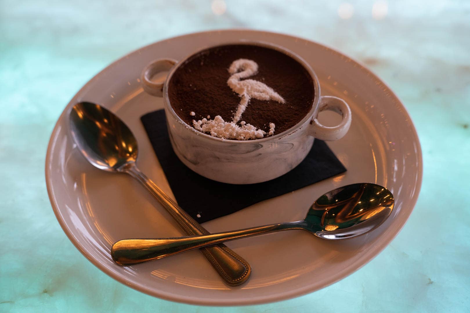 a cup of chocolate with a design made of sugar on top