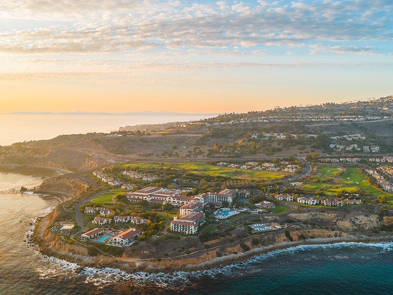 A aerial view of a coastal resort at sunset