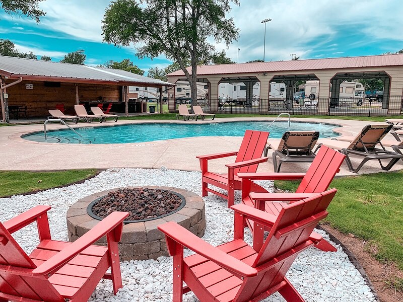 the pool and fire pit at great escapes austin oaks 