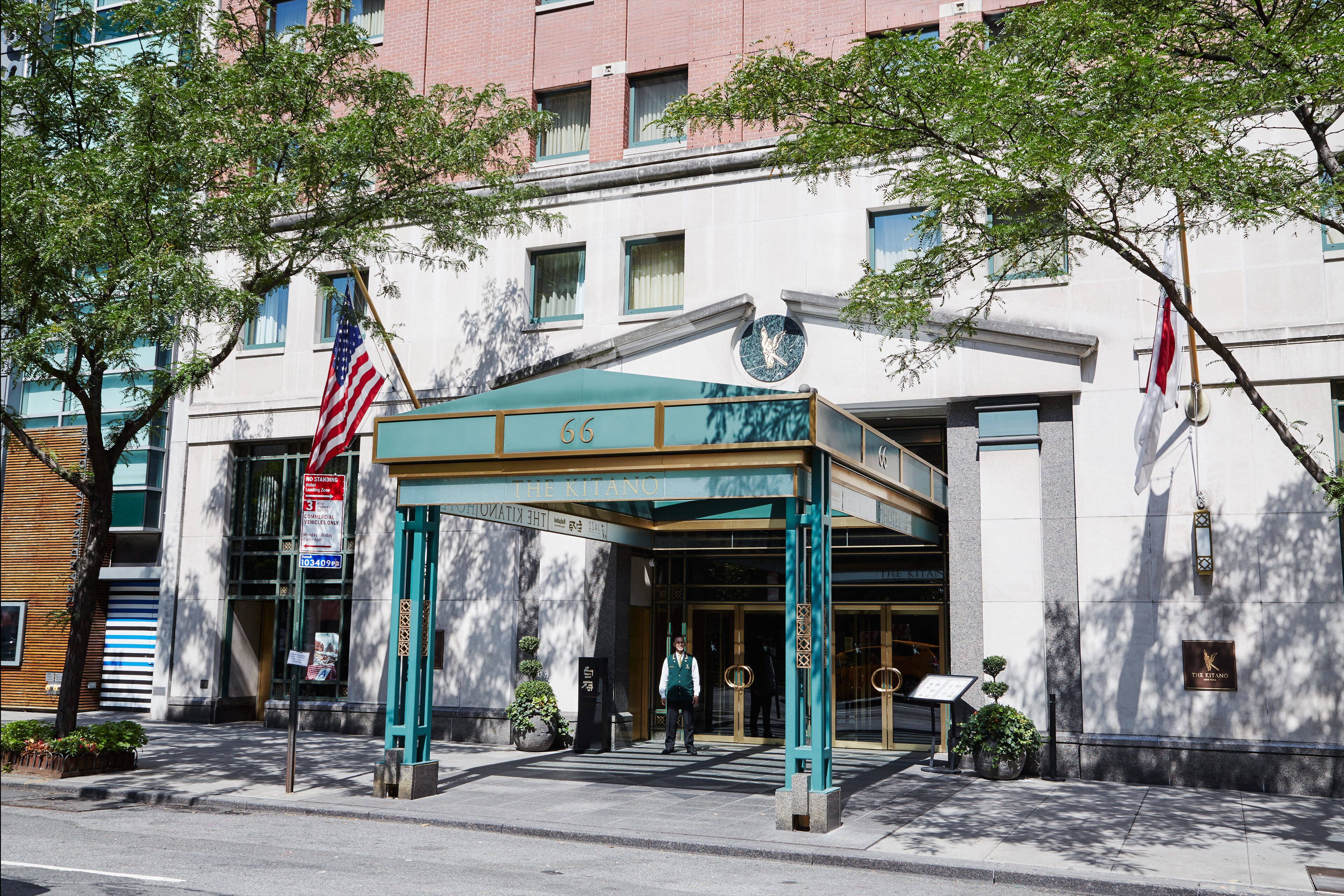 The front entrance to a hotel with a green awning, The Kitano Hotel New York
