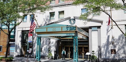 The front entrance to a hotel with a green awning, The Kitano Hotel New York