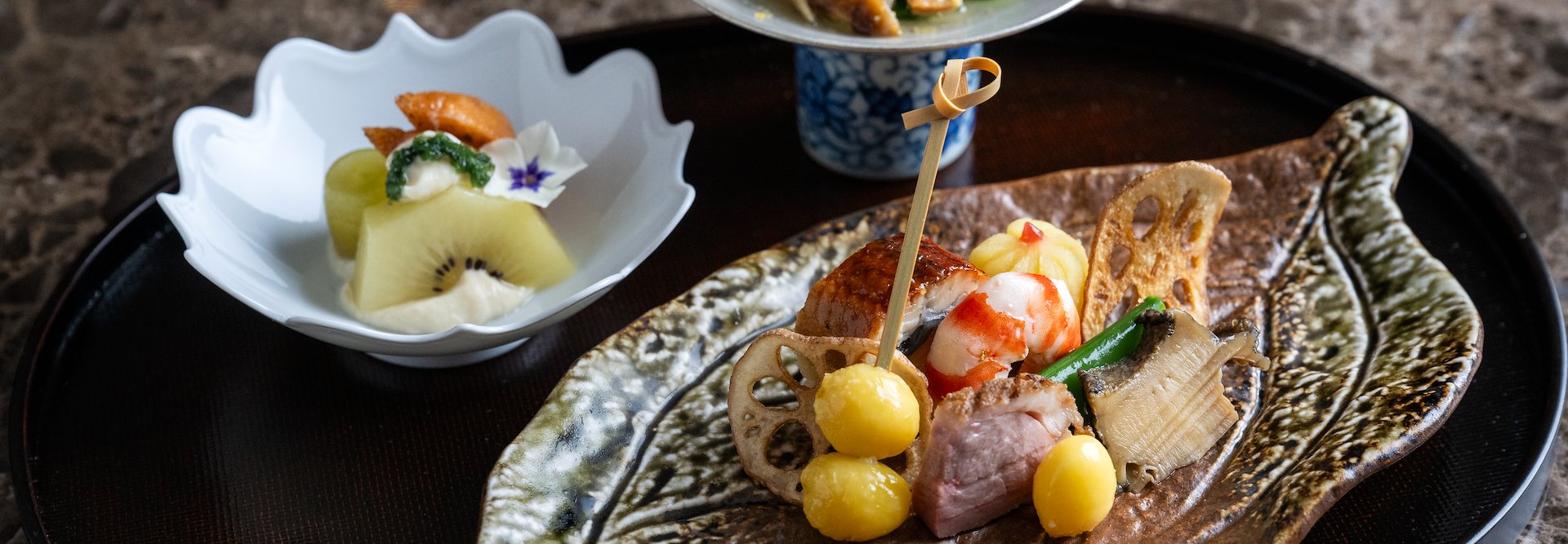 A plate with food on it and a bowl of fruit, The Kitano Hotel New York