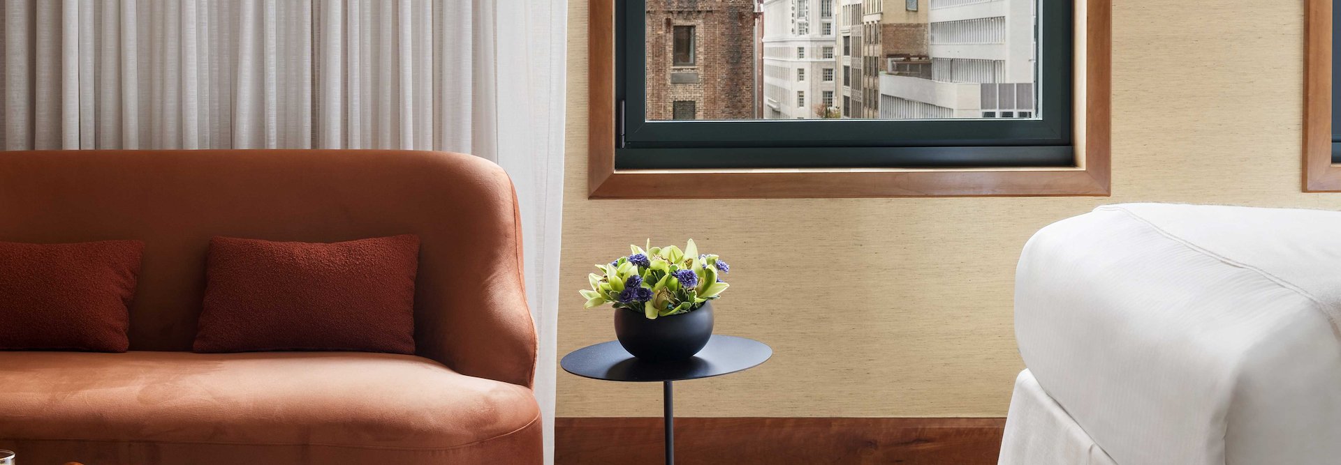A hotel room with a bed, couch and a window, The Kitano Hotel New York