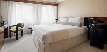 A hotel room with a bed, desk and chair, The Kitano Hotel New York