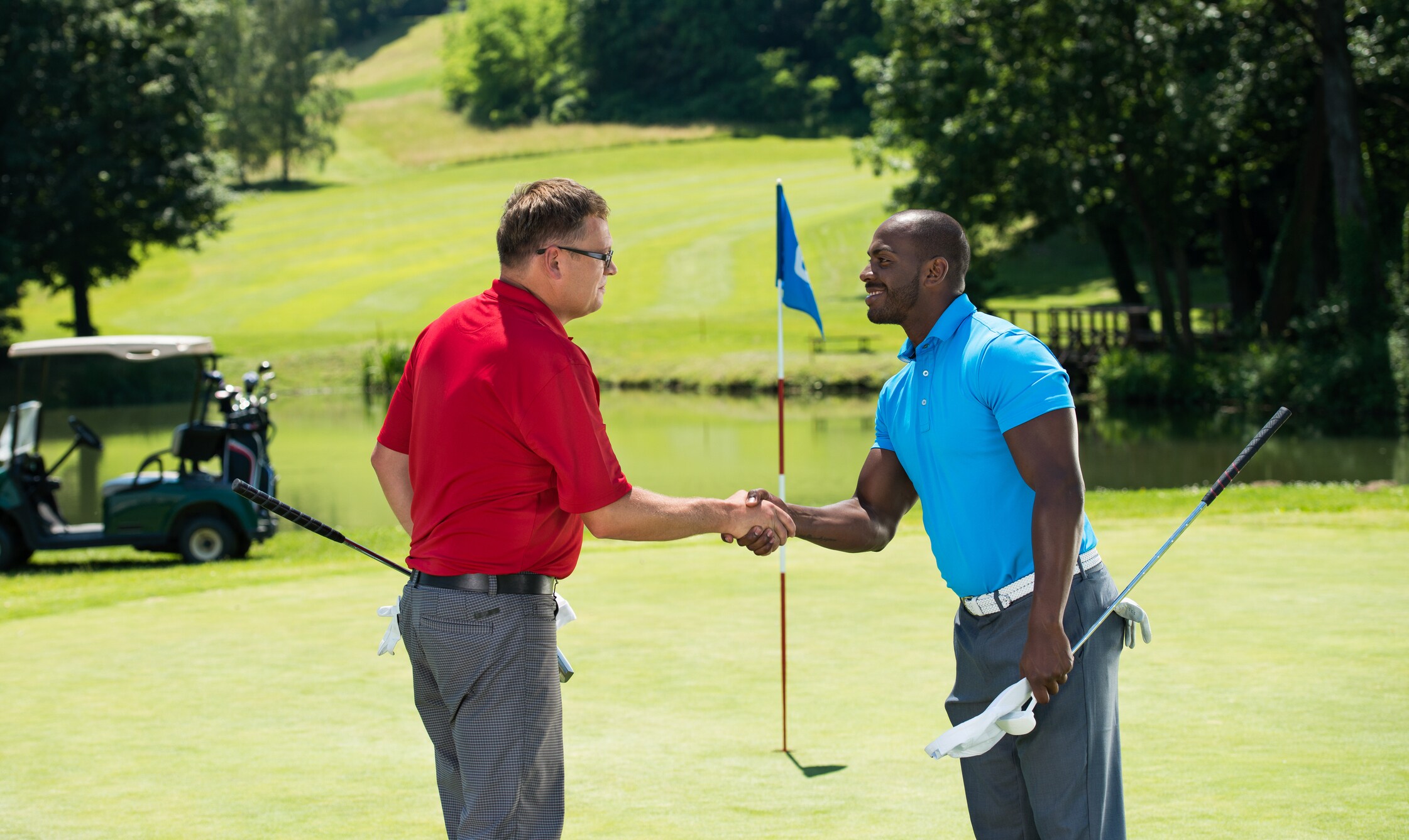 Two golfers shaking hands after a match at Leatherstocking Golf Course in New York