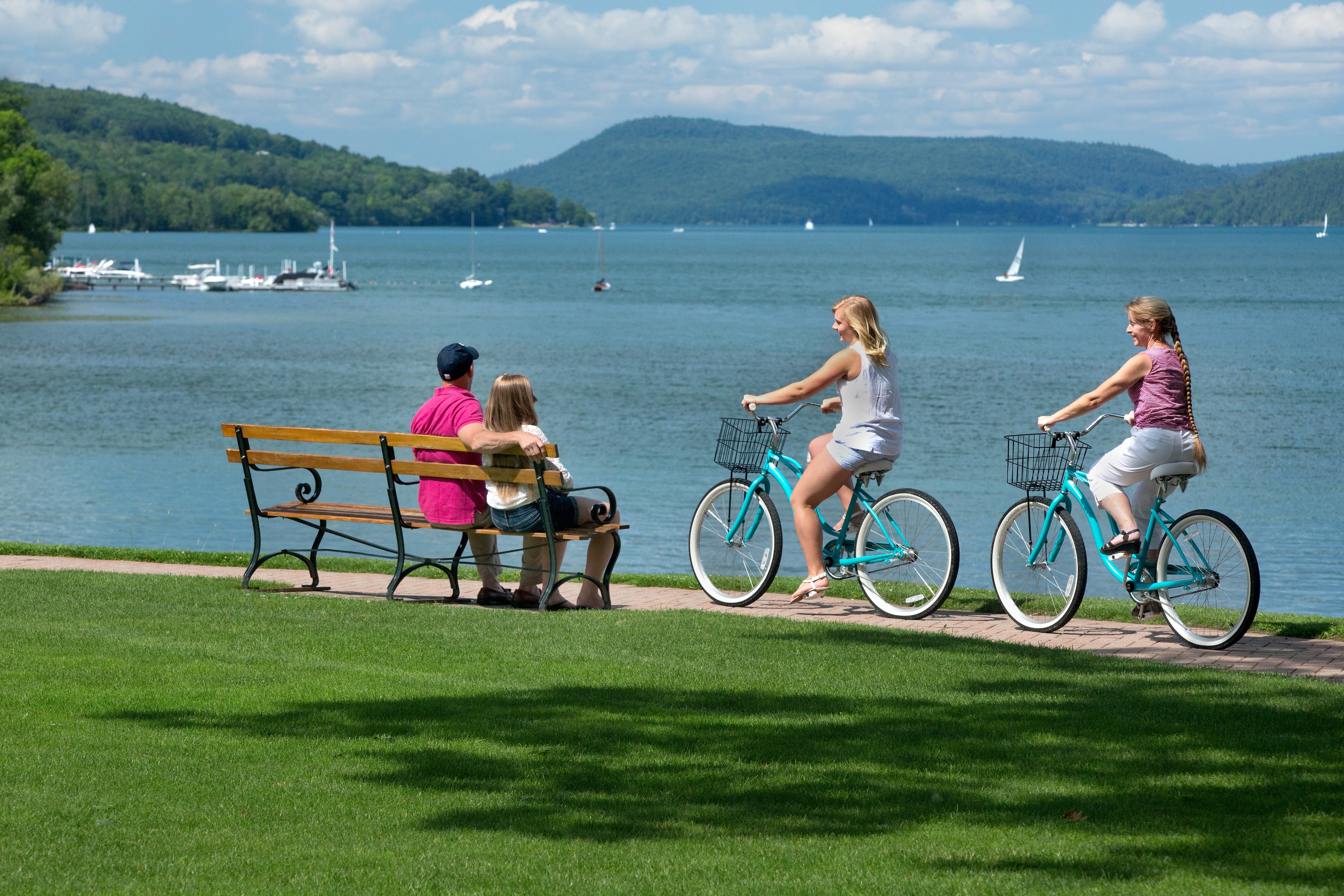 Guests bike and relax by the lake at The Otesaga Resort Hotel, New York