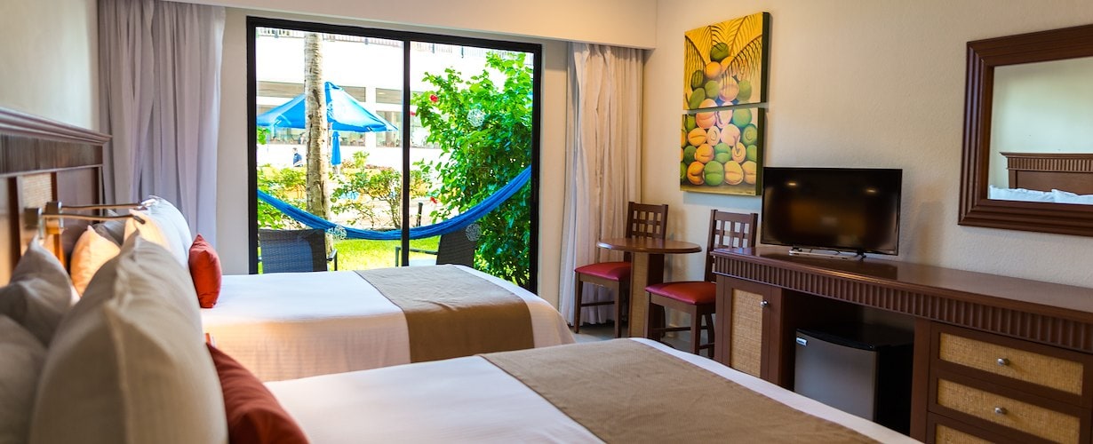 Two double beds - Pool view of The Reef Coco Beach, Playa del Carmen, Quintana Roo