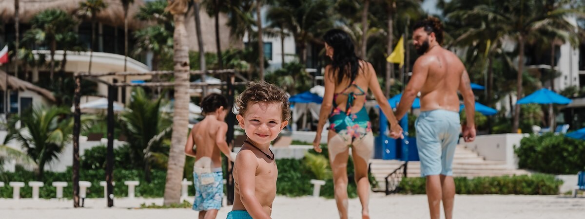 A smiling child enjoys the beach at The Reef Resorts in Playa Del Carmen.
