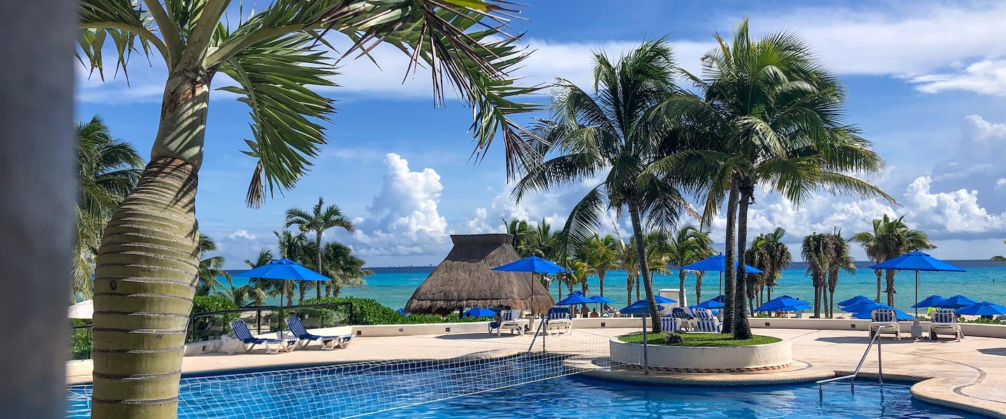 The Reef Playacar Beach Resort & Spa features a stunning pool with ocean views.