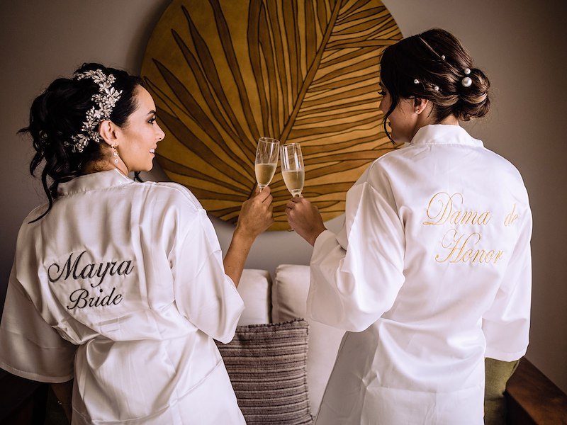 Women in white shirts holding wine glasses