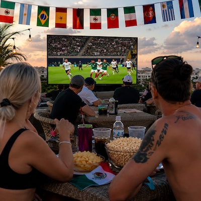 Guests enjoying live soccer matches at The Reef 28 in the rooftop, Playa del Carmen, Mexico.