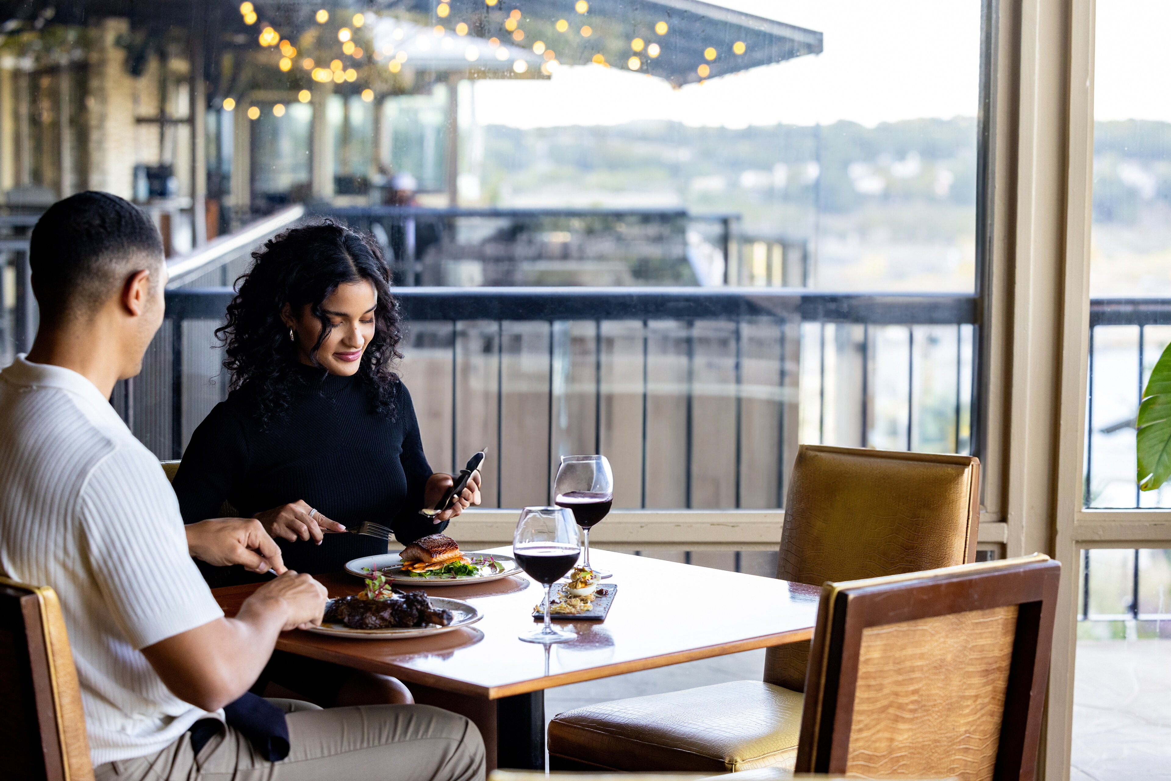 A couple enjoys a meal with wine at Lakeway Resort & Spa, Texas