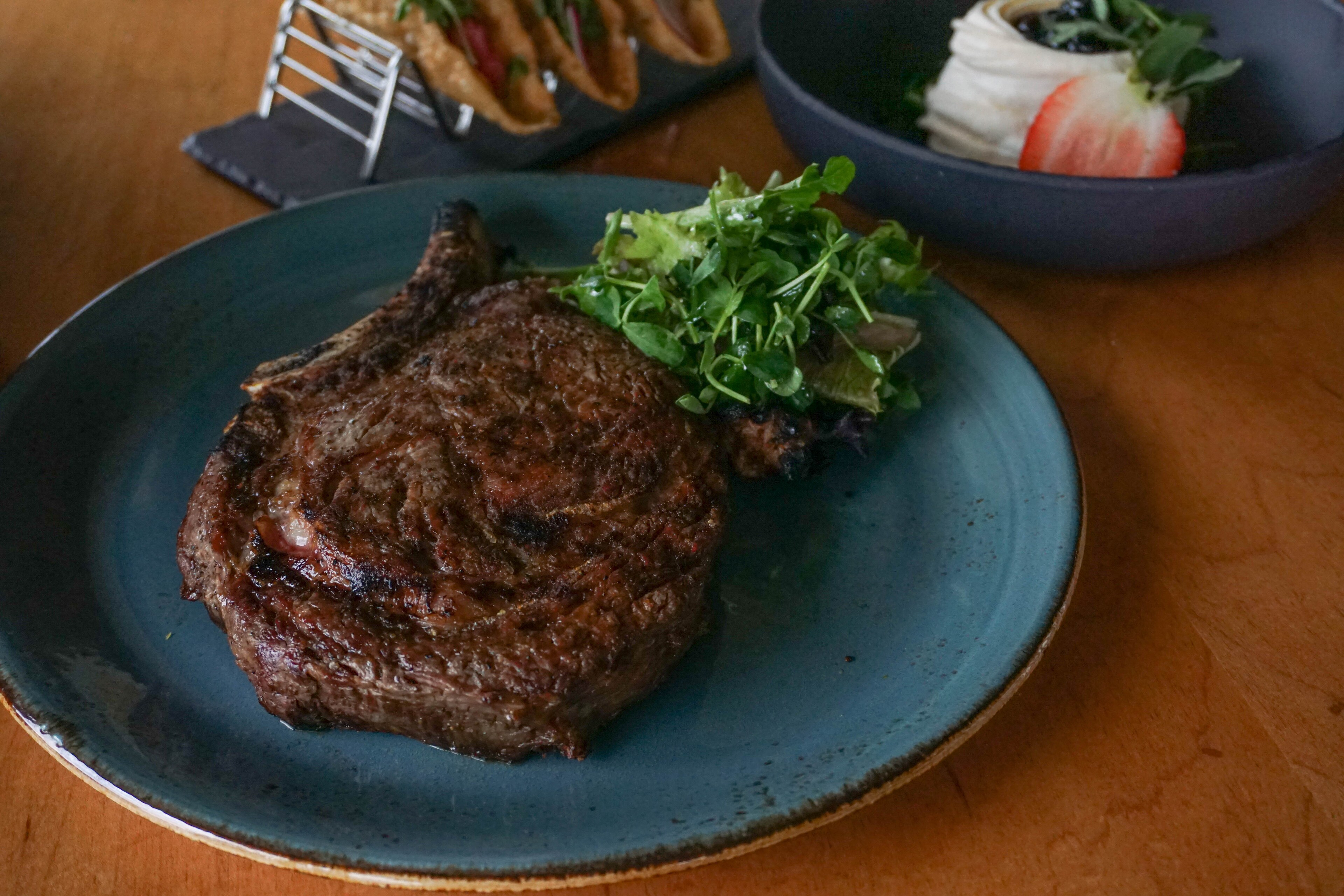 Grilled ribeye steak served with fresh greens at Lakeway Resort & Spa, Texas