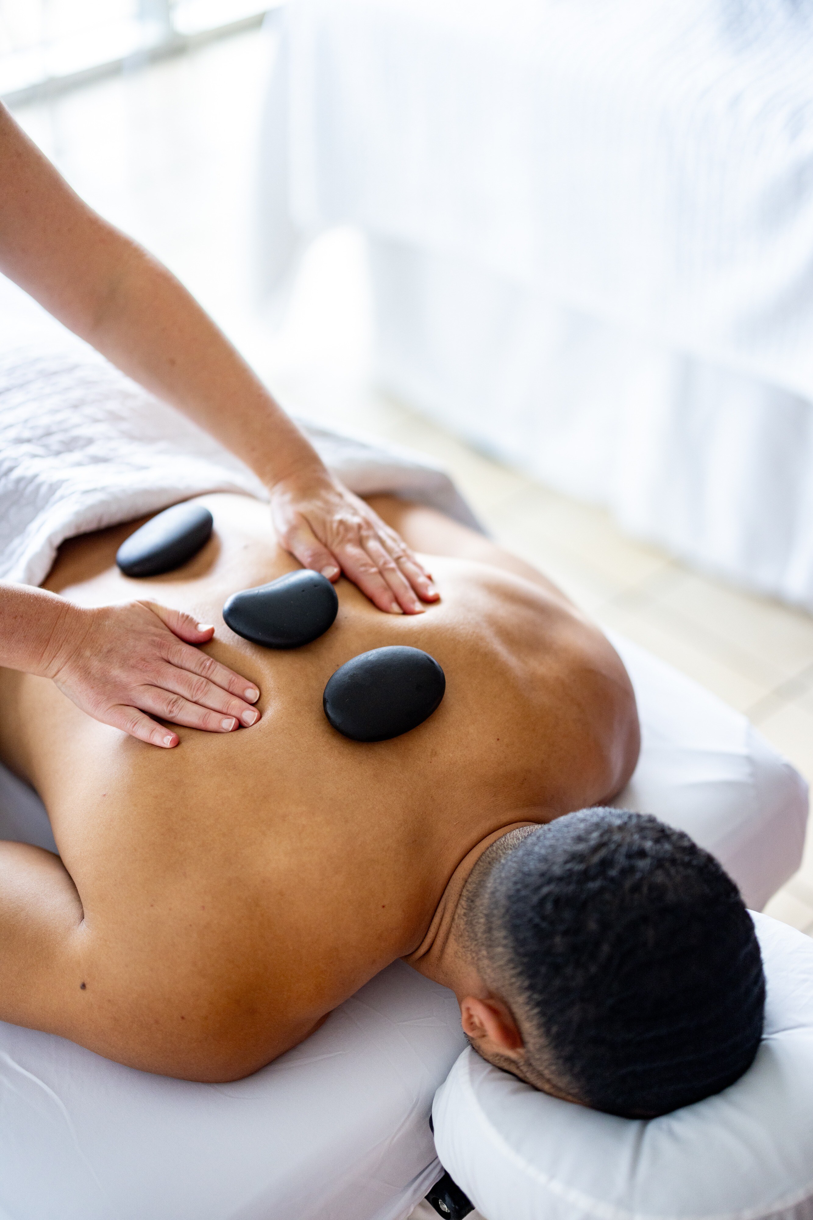 Man receiving a relaxing hot stone massage at Lakeway Resort & Spa, Texas