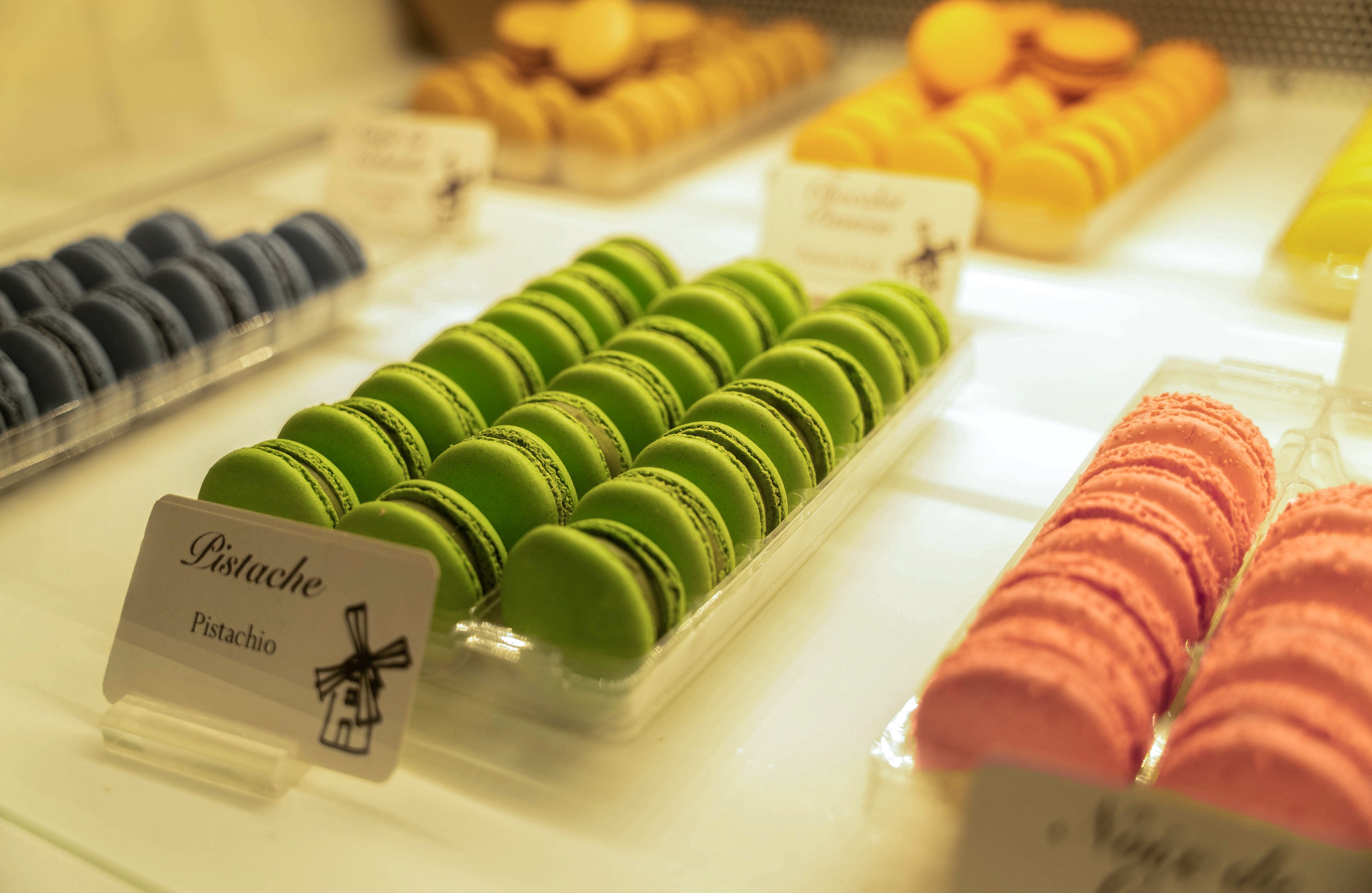 A display of colorful macarons on a white counter.