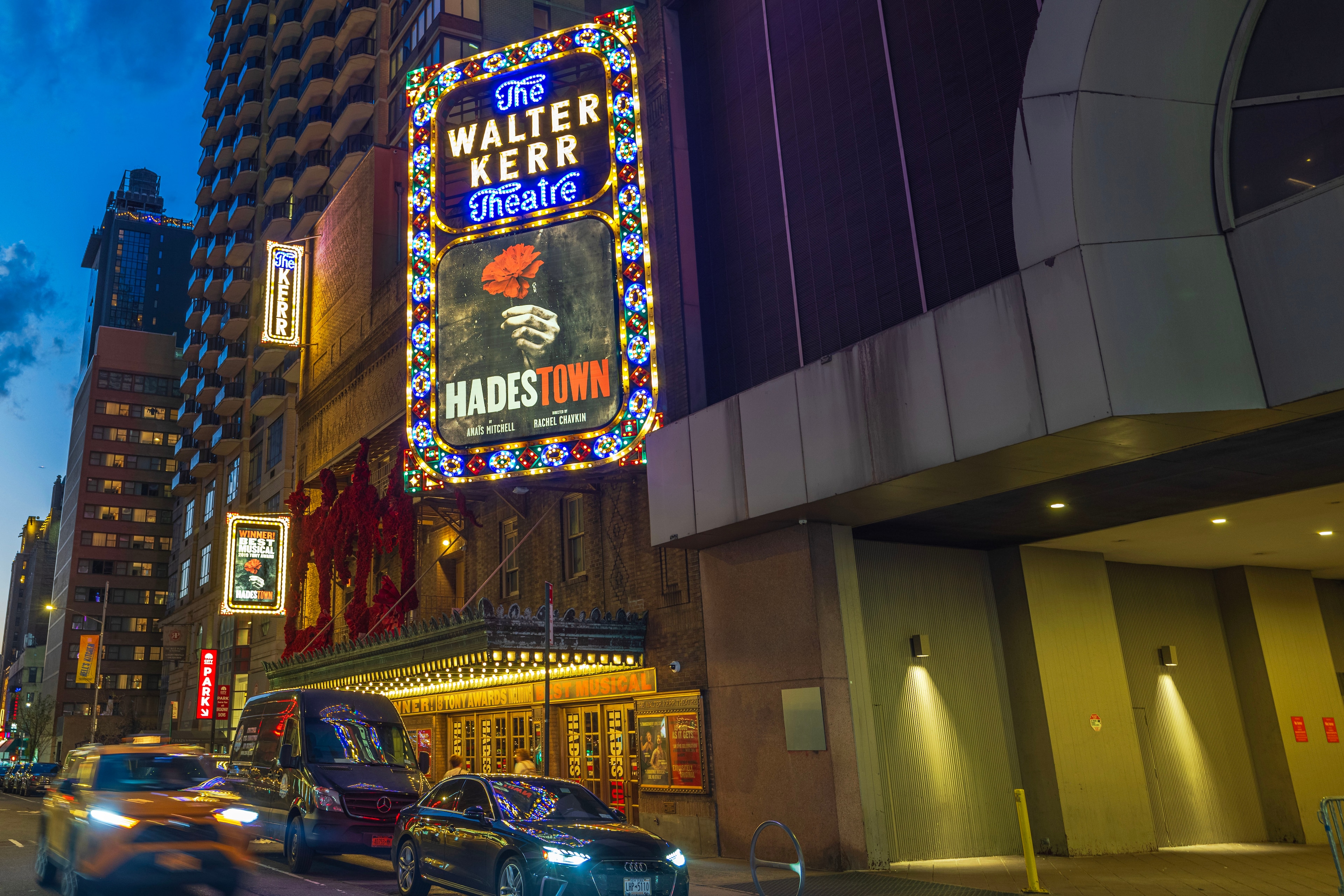 A photograph of a theater marquee at night