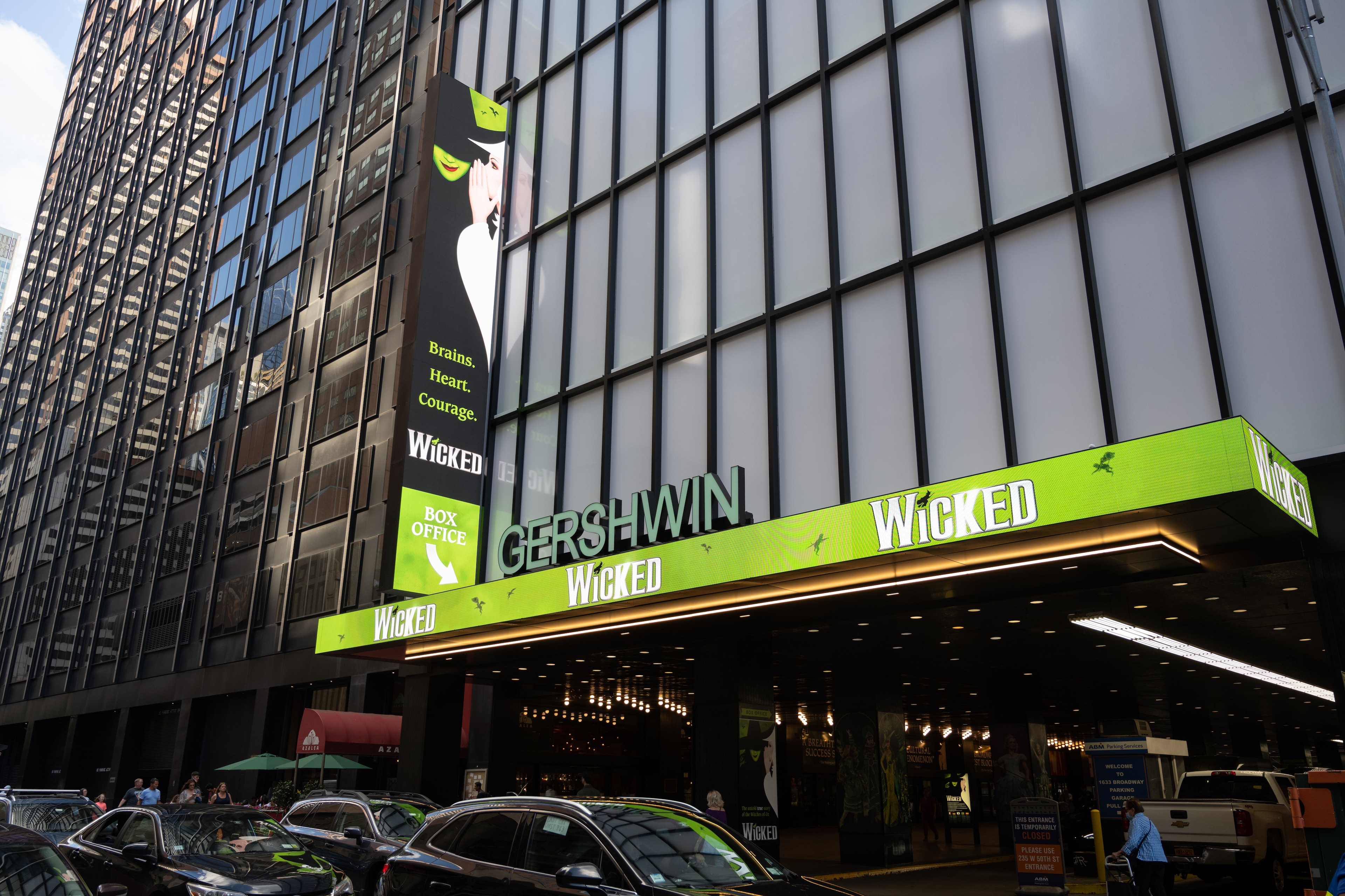 A photo of the exterior of a building with a green and white sign that reads Gershwin and Wicked.