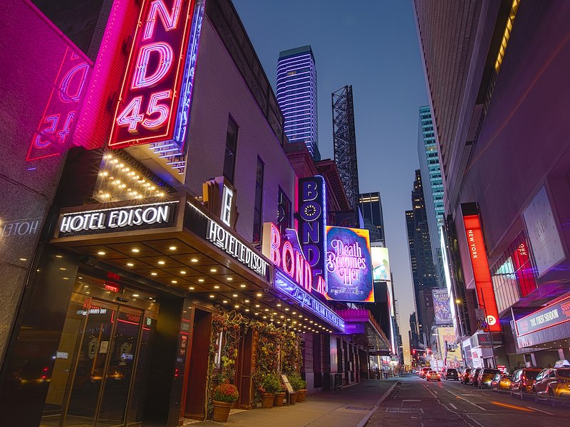 A city street with neon signs