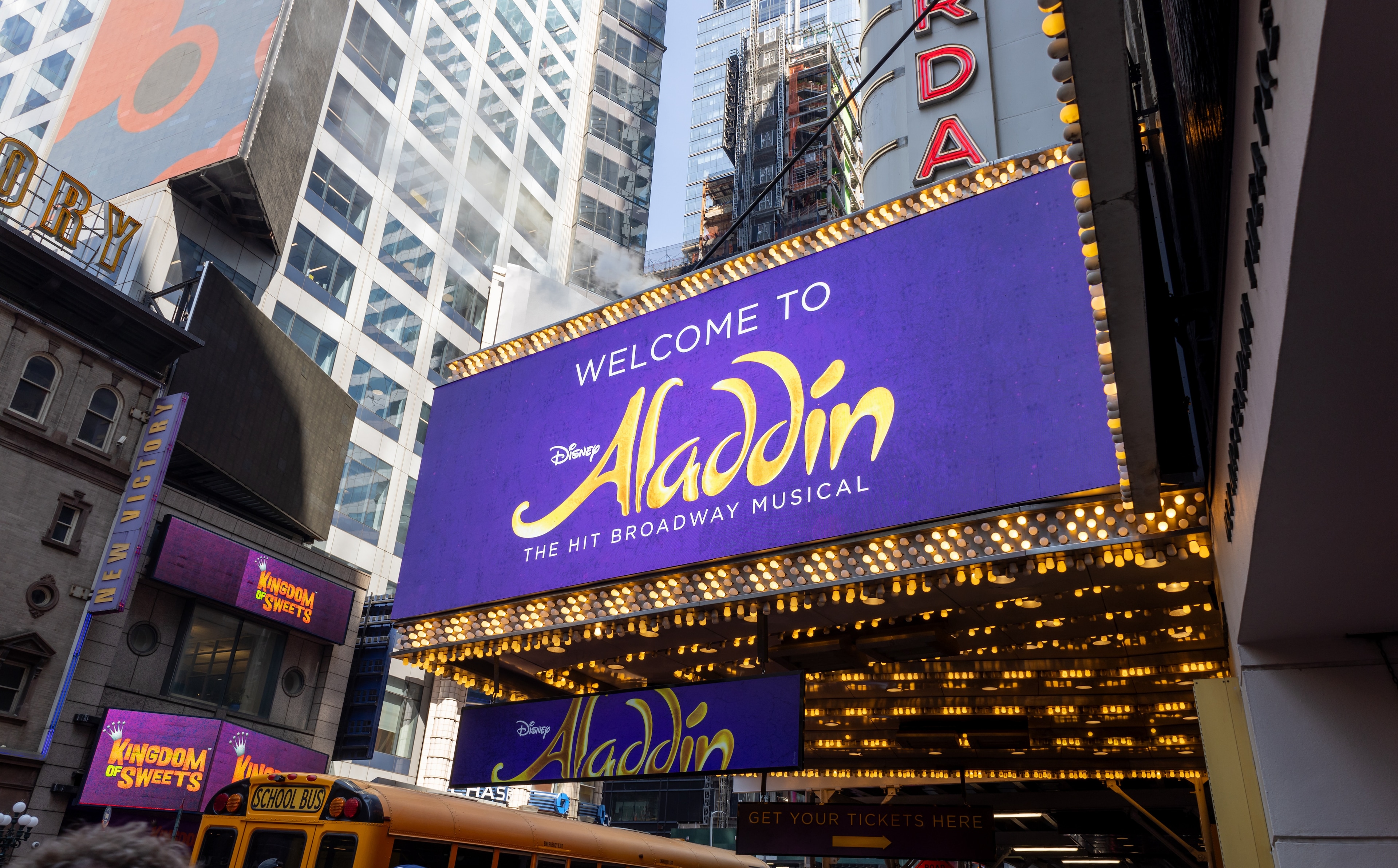 a large purple billboard on a theater building
