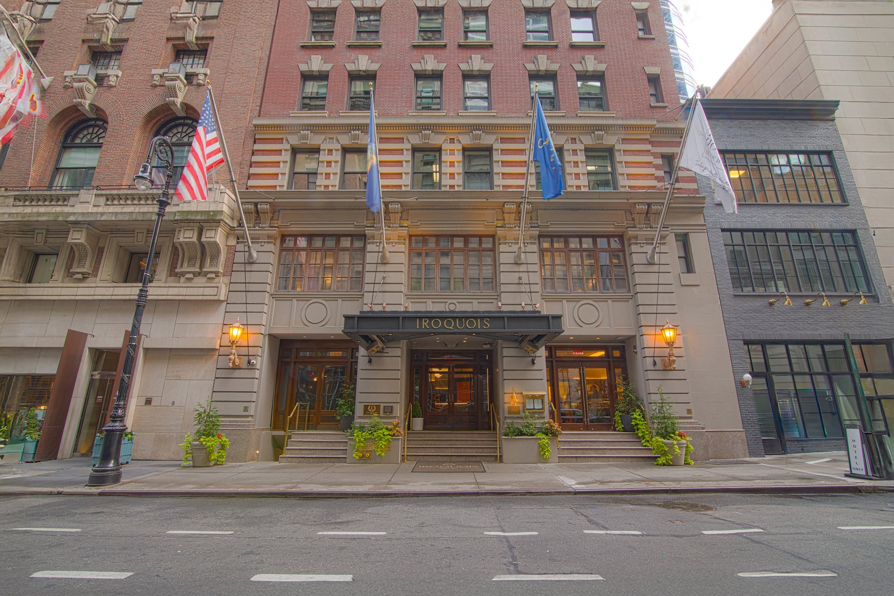 The facade of a multi-story building with the name 'Iroquois' above the entrance.