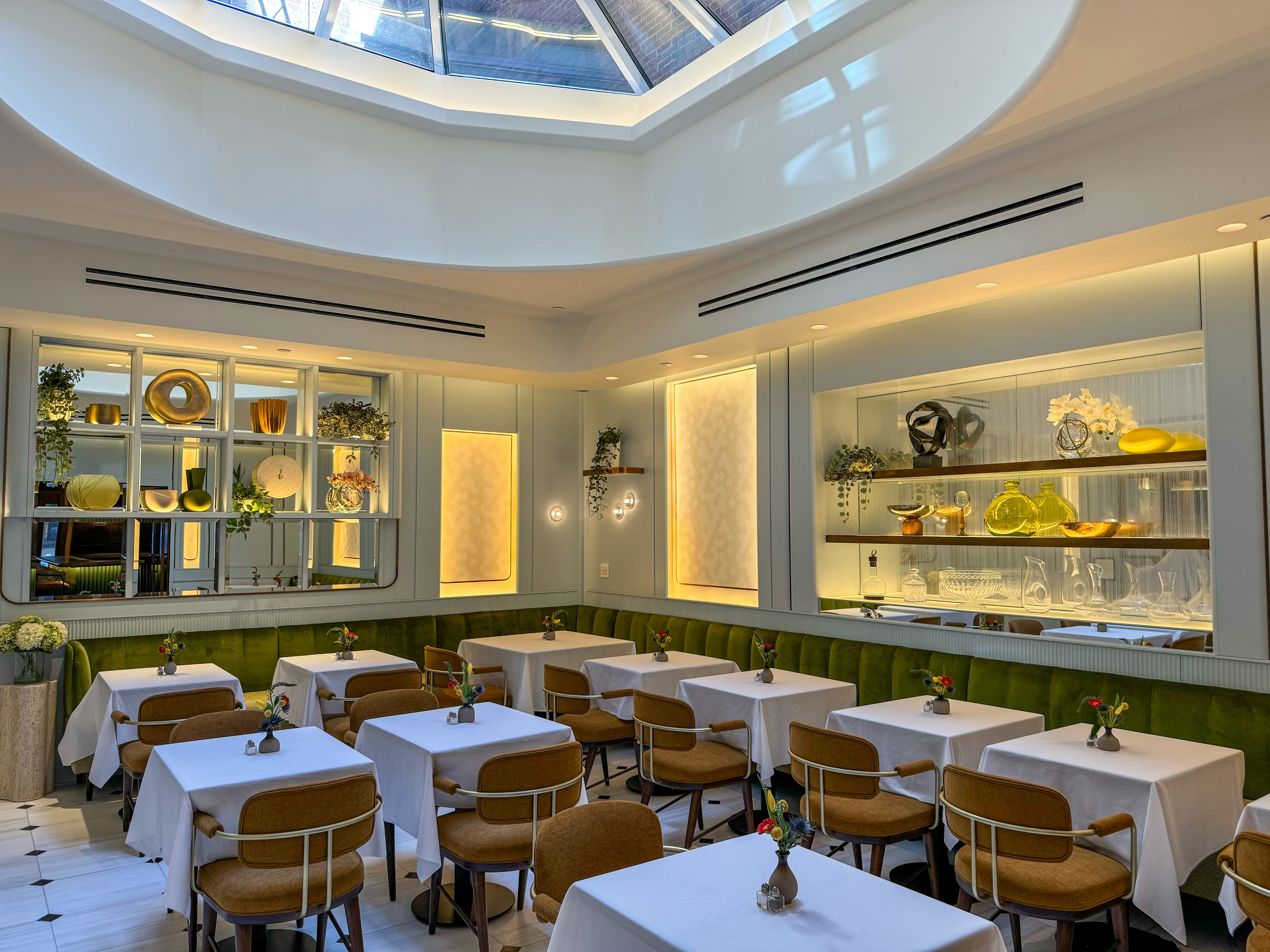 a dining area with white tables and brown chairs