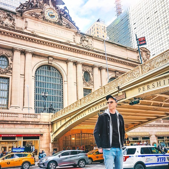A man stands in front of Grand Central Terminal in New York City.