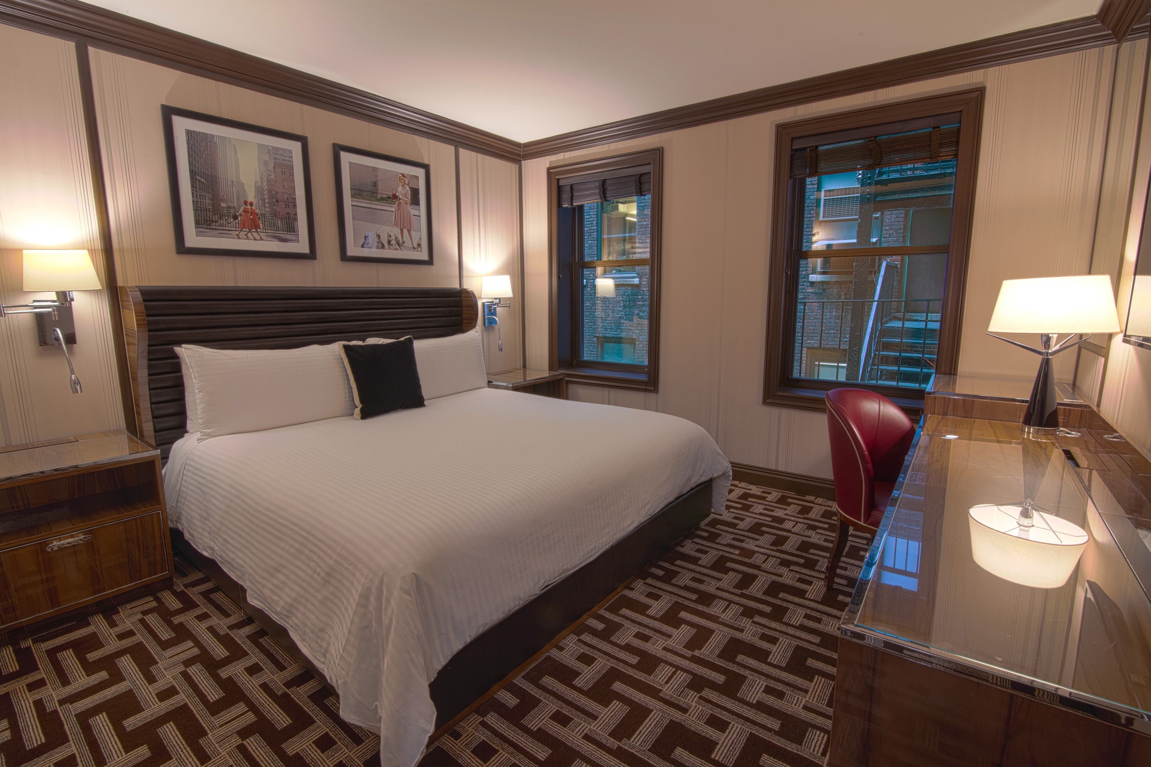 A hotel room with a large bed, two nightstands, and a window.