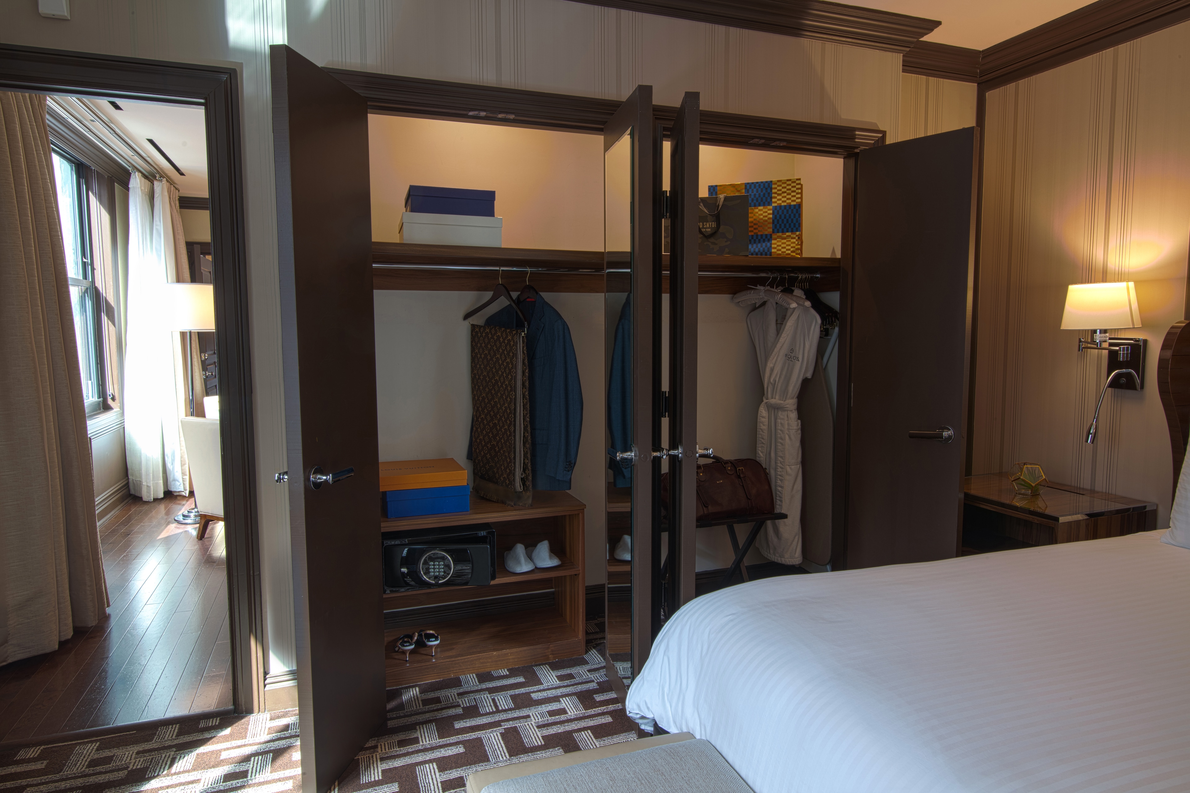 A hotel room with a large closet and a bed