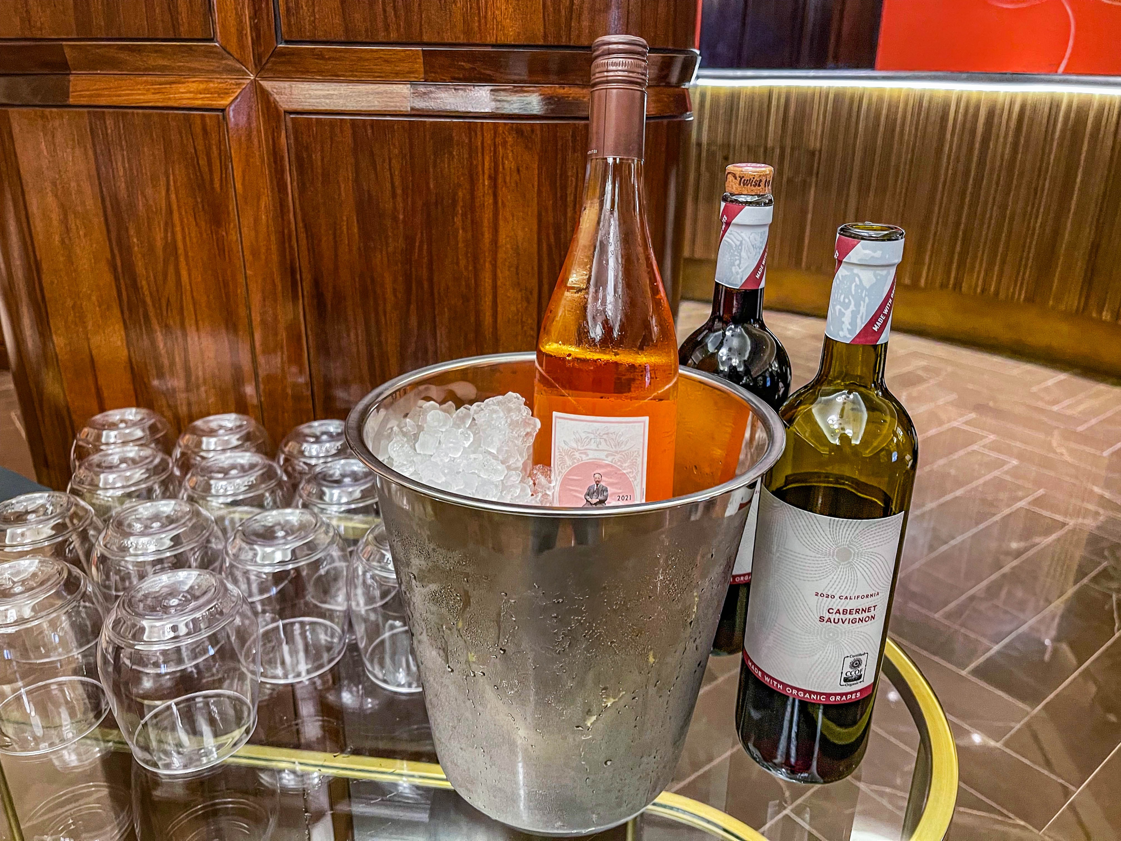 a champagne bucket with ice and wine bottles on a bar
