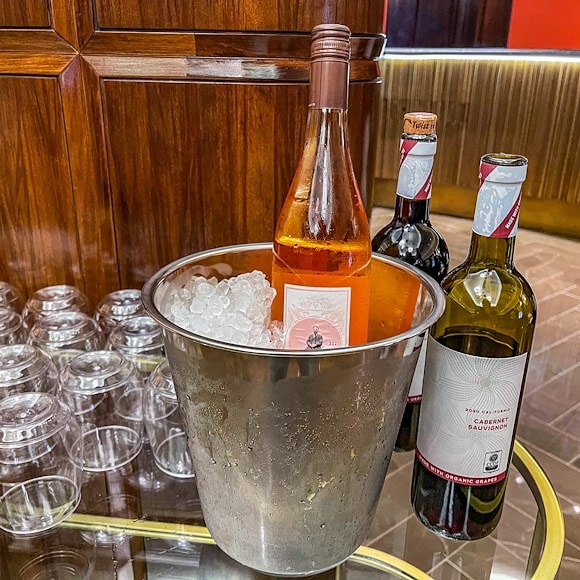 a champagne bucket with ice and wine bottles on a bar
