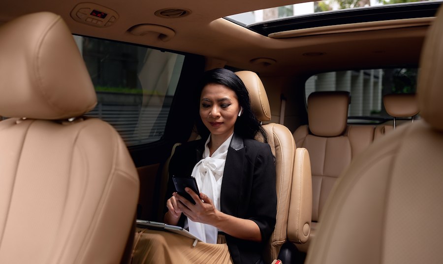 Businesswoman sitting at backseat of a taxi