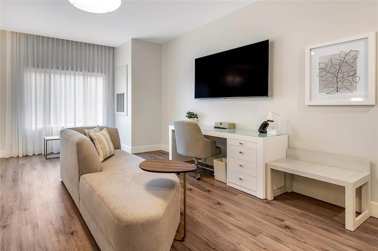 A clean, modern hotel room featuring a desk and chair, designed for comfort and productivity at Cambria Calabasas Hotel.