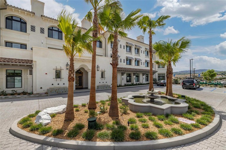 Courtyard at the Cambria Calabasas Hotel, featuring lush greenery and elegant seating areas in a serene resort setting.