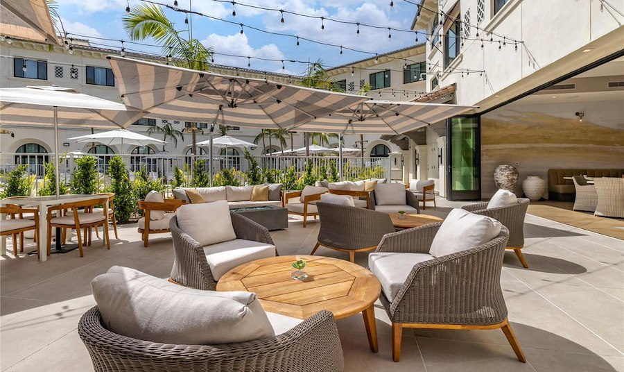 A patio with chairs and umbrellas
