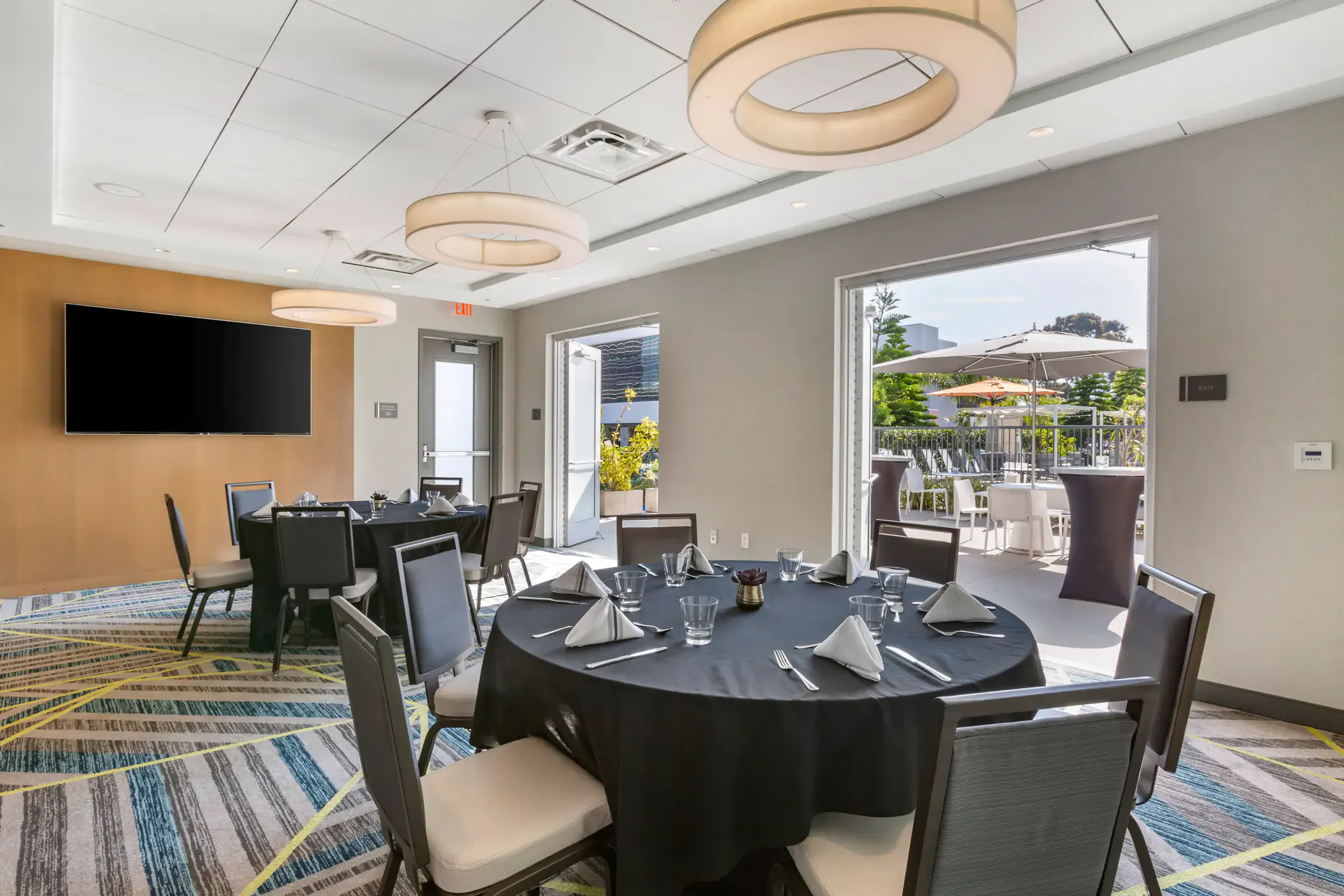 Modern dining room with round tables, set for an event