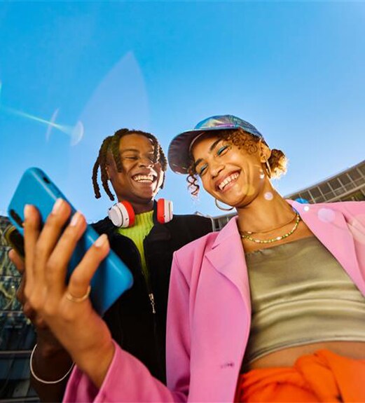 Smiling young woman looking at her checking account on her mobile phone.