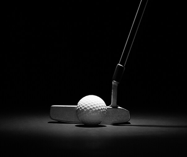 Close up view of golf putter and ball