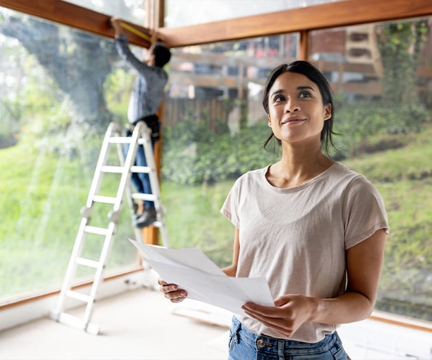 Woman looking confidently at her home improvement project
