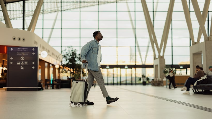 Man in the airport walking to his flight for summer travel. Man in the airport walking to his flight for summer travel.