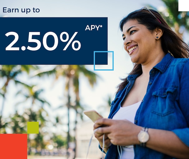 A smiling woman looks up from her phone