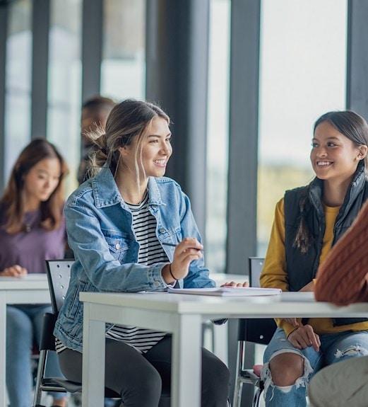 A group of students sitting a table and talking