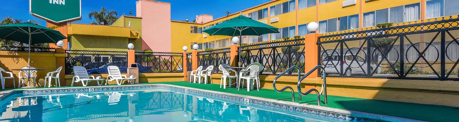 Outdoor Swimming Pool Area With Seating Area at Vagabond Inn, El Segundo California