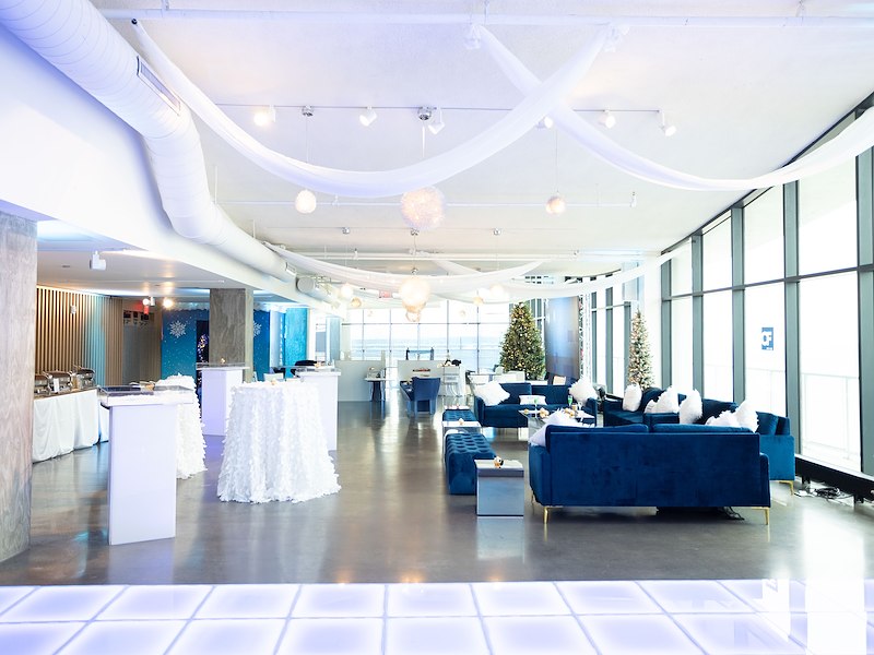 indoor lounge setup with blue seating, holiday decorations