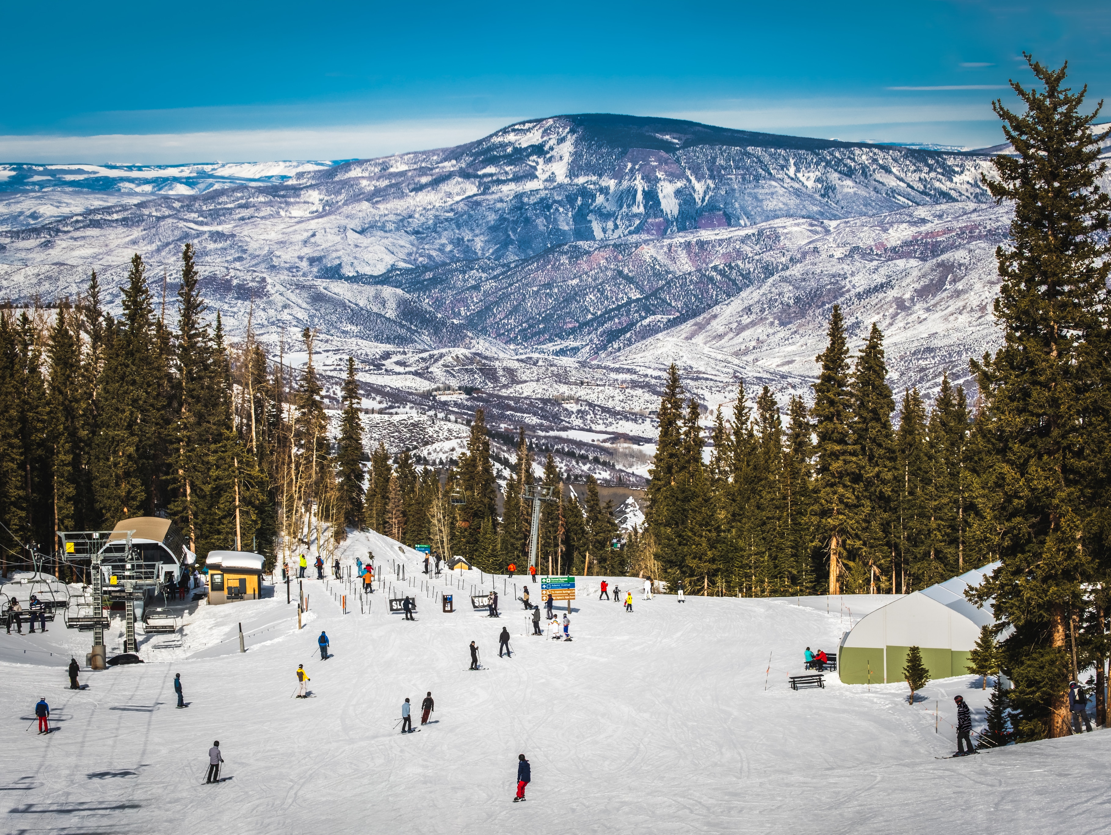 Scenic view of skiers in snowy Colorado mountains.