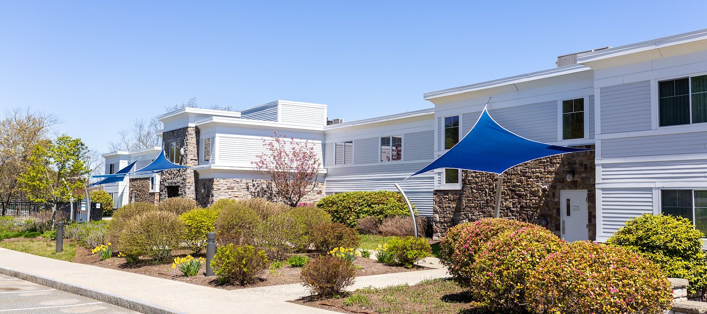 A modern Atlantic View building with a stone facade and white accents